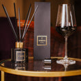 Load image into Gallery viewer, Aromatherapy diffuser, box, and wine glass on a table with a blurred background
